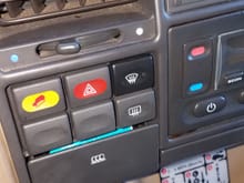 The bottom left is the kill switch, the car only runs when the button is pressed down. I changed the face from an emergency light switch like above with a blank so it wouldn't stick out