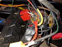 More creative wiring, someone thought it was a great idea to jump the window wiring to each other with the large orange and black wires.  Then tap into the ignition wire with a fuse holder(large yellow wire) and ground it to the frame of the center console mounts.