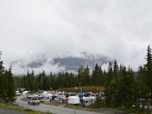 Snow on the close mountains, look past the vendor area.