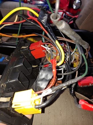 More creative wiring, someone thought it was a great idea to jump the window wiring to each other with the large orange and black wires.  Then tap into the ignition wire with a fuse holder(large yellow wire) and ground it to the frame of the center console mounts.