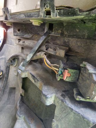 Wrap a zip tie as shown around the bumper retaining bracket on the fender.