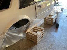 How do you like my home built, wooden jackstands?  Lots of online info on building them out of 2X4s.  They're very sturdy and extremely stable.  This car body is very light so I actually trust them more than I trust real jackstands.