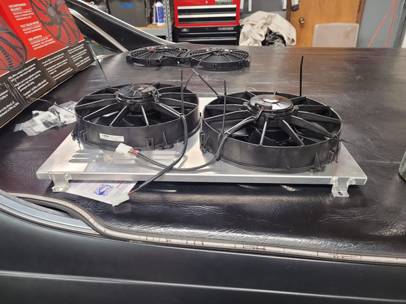 I had to trim about a 1" larger opening in the shroud even though the old fans (in the background) and the new ones are both listed as 12" fans