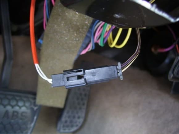 Unplug this connector and install resistors across the white/black and purple/white wires (leave the orange sheathed white wires disconnected).