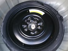 Deflated spare tire in spare tire well