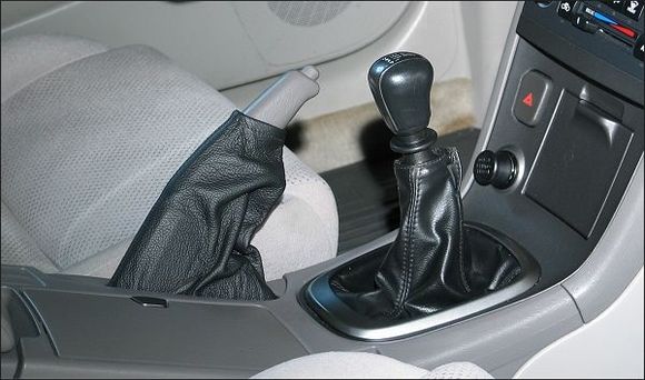 RedlineGoods.com for the leather e-brake boot. Not a perfect match for the shifter boot, but a world better than going commando. It was a glaring design flaw on the 5th Gen interior, not to have a boot around the e-brake.