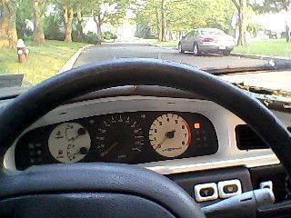 Custom gages, White rpm-(with Bright orange needle) White gas and water temp-(White needle) original black speedometer (Bright orange needel),  and turnsignal light (white). Also volt meter mounted on left just outa pic (pic soon). I did myself I dont think anyone else has anything like this in there maxima which makes mine one of a kind. 120,xxx on odom I think. I snaped the pic right as the security light flashed, owned!