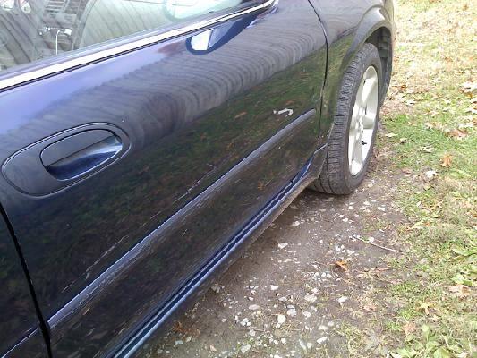 Pictures of the scratched, dent passenger side door