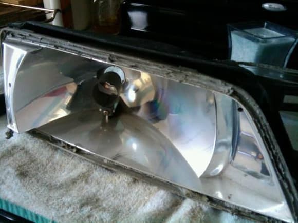 Cooked headlight in the oven @250 for 10 minutes to remove glass. Faded chrome needed attention!