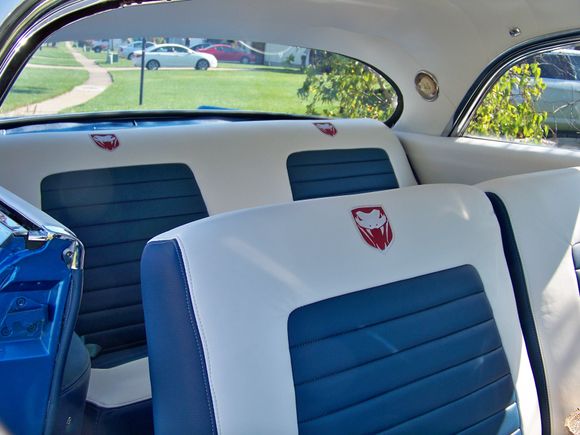 My upholstery person said we need to spice up the interior a little. She said she had a friend who could do embroidery.  This was the first complete car interior she did! Materials are leather and urethane.