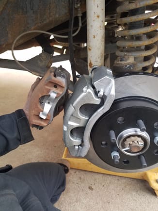 old brakes next to new ones