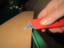 Trimming Masonite 'bloom' from drilled holes on back side of panel