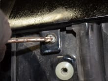Remove screw behind pillar trim panel.
