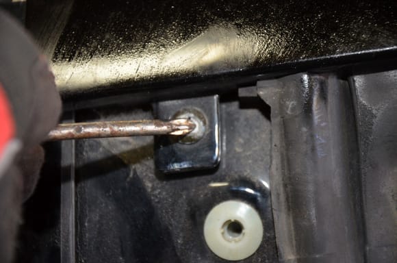 Remove screw behind pillar trim panel.