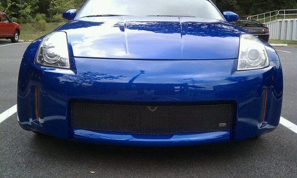 Grillcraft black mesh grill installed, Nissan emblem shaved, license plate holes filled, everything smoothed over and re-sprayed.