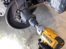 Put a wrench on the nut of the bearing puller. 