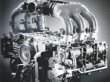 A photo from the 2003 Porsche Exclusive catalog (p. 13). This shows the aluminum intake manifold. It also shows an oil line running from the front of the engine to a dual-action oil pump at the back. This is actually an option, not standard.