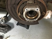Rear rotor, caliper, hub halves removed to expose bad wheel bearing