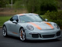 (I think) Sport Classic Grey (or maybe Fashion Gray, I'm honestly not certain) on a 911 R with what appear to be Signal Orange stripes and a deviating grey stripe. Also custom painted brake calipers to match. Satin Aluminum wheels.