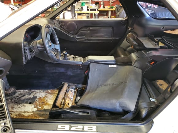 You can kind of make out the missing chunks of the rear top console cover in this photo.  Also pictured are the old rear seats that were in tough shape.  The driver's side latch mechanism was completely frozen and wouldn't release.  Got it to move with a long pry bar so I could get them removed.