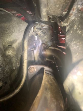 This is looking up towards the cam tower gasket area. I am pretty confused as I had thought that having replaced both the bolts and the gasket that it would not leak here but this is slightly contrary to that. You can also see oil puddled on the bottom of the #4 exhaust header