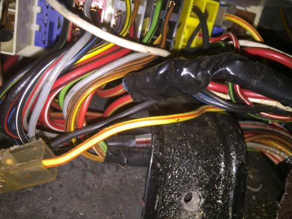The wire under the electrical tape is bown, goes through firewall and to 14 pin