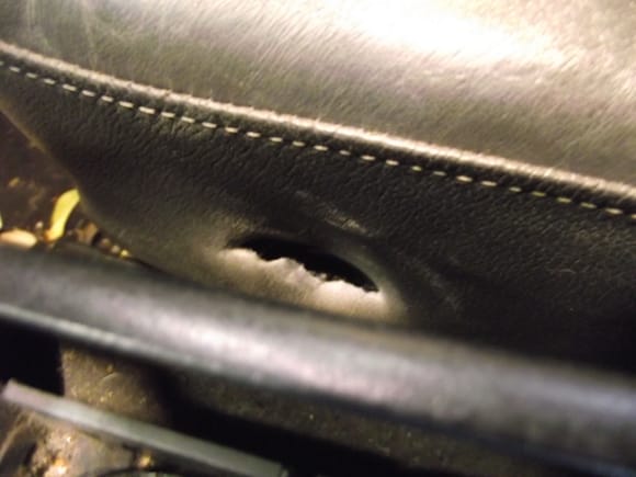 The slot cut into the front inner part of the seat to access that bolt.