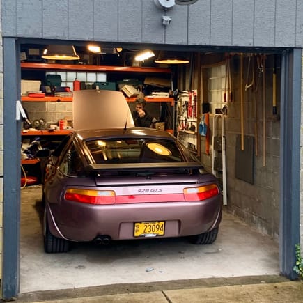 Here she is in my very small garage. The color is showing it's bronze tones on a cloudy day. The cassis red metallic is known for looking different in various lights and this is my favorite tone.
