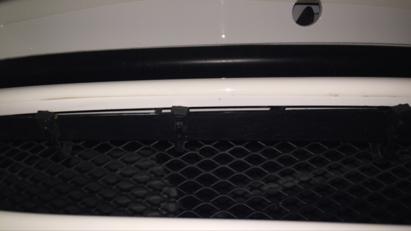 Cable tie hidden in between the support and the bumper cover