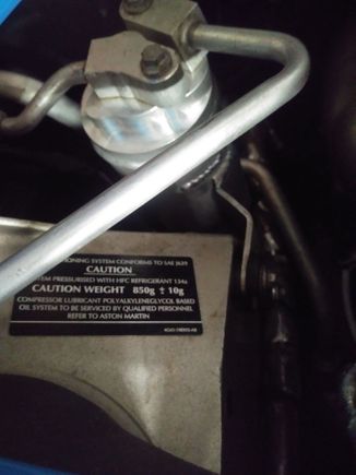850 Grams of R-134.  Sticker is on RHS shock tower.