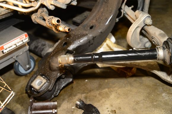Remove the outer spring clip (the thicker clip), then the rest the CV boot. Clean everything thoroughly afterwards.