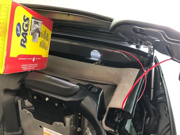 '06 DB9 Volante with cardboard box holding roof lid open.
NOTE THE GIANT HOLE LEADING TO THE BOOT (NORMALLY COVERED BY BOOT CARPET)!
The red "wire" is just a fish tape I didn't end up using...