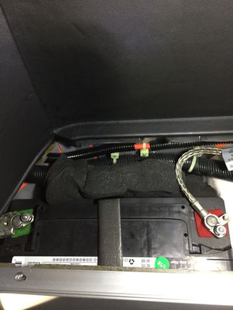 Once the shelf and retainer/finisher is removed remove the foam from behind the battery to reveal the rear fastener of the secondary retainer bracket.