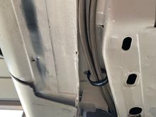 This is where the stainless fuel lines pop out under the frame or out of the frame. Either way you wanna look at it. They’re tucked up underneath where they won’t hang down. Of course they have a clamp to hold them as seen here and other places.