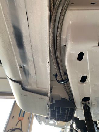 This is where the stainless fuel lines pop out under the frame or out of the frame. Either way you wanna look at it. They’re tucked up underneath where they won’t hang down. Of course they have a clamp to hold them as seen here and other places.