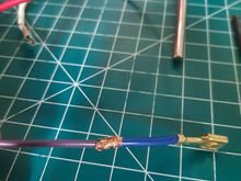 I like to slightly crush them with wire strippers to make them low profile and to prevent them from sticking out of the heat shrink tubing 