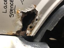 The majority of the rust, just above the bumper cap. 