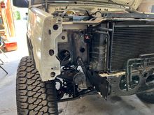 Preparing to remount the fenders by reinstalling brackets 