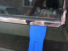 Gently use plastic trim removal kit to pry the trim pieces off.  The bottom one is first on each window.