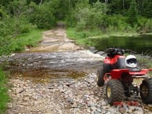 Quading, one of our wash outs, a small one at that. this water from the pond, does not flow over the trail, but excessive rain falls have this thing flowing pretty good.
