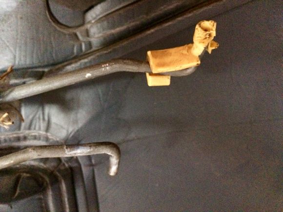 Close-up of the latch mechanism rods.  The have a simple “L” bend to them, with little plastic caps that fit into holes on the latch mechanism.