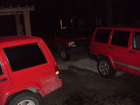 the dirty jeep on the left is mine.. the jeep on the right is my sisters, she bough it new in 2000.. the jeep in the back is my buddys 93 sport.. 3 red jeeps in my drivway..haha to bad i didnt have my RED 93 country in this pic too..