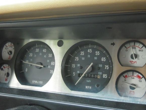 Aluminum bezel on cluster with whitened gauges on the sides backlit by white LED's (not visible in pic/daytime)