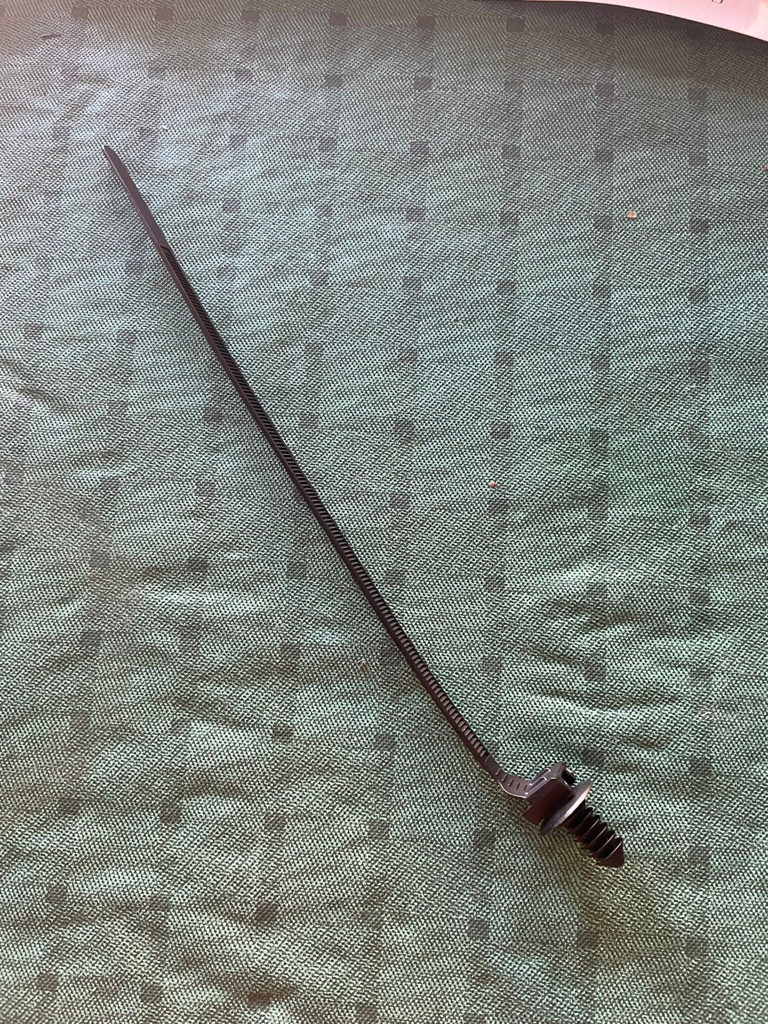 This is the only zip tie I could find that will work. Grind down the pine tree at the end until it will screw into the threaded holes easily, using lithium grease.