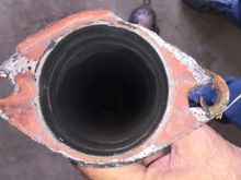 The flange in the end of the catalytic converter down pipe, gasket still stuck on.