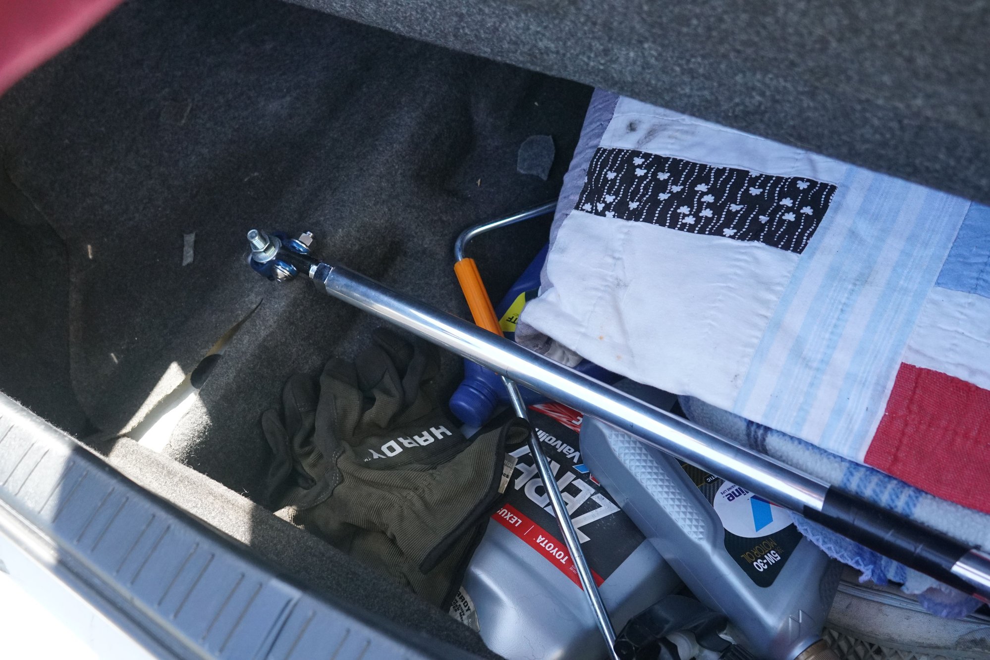 Drivers side mounting of the trunk bar. Ignore extra use of storage space.