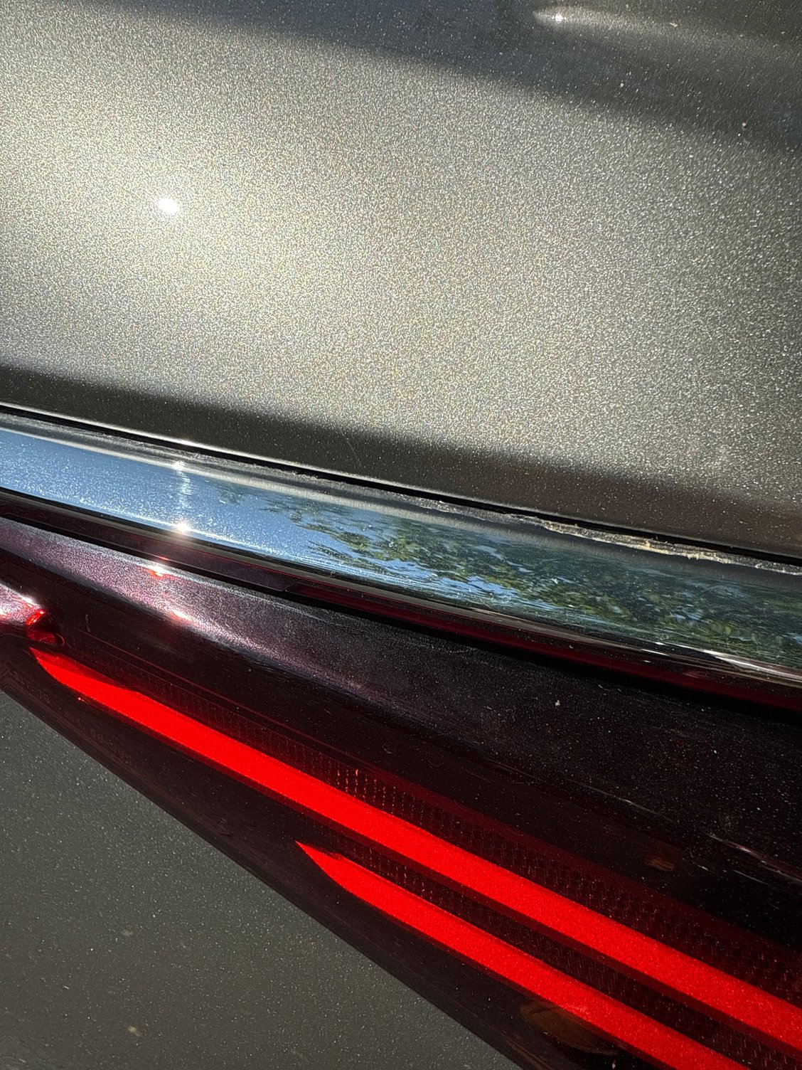 Can you see the thin black gasket between the chrome piece and the silver part of the car? I had no issues peeling off and transferring it from the original piece to the new piece.