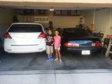 The kids posing in front of our cars.