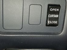 No air purifier but this button opens rear shade curtains and closes them when you want.