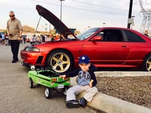 96 Nissan Skyline GTR shod in it's street attire.  3 piece Volk GTC Face 2 rims in Top Secret gold and polished chrome lip.  My 2 year old with his 60's pedal car done up as a Dodge Demon in Sublime Green.